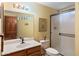 Bathroom featuring a vanity sink, toilet, shower, and a large mirror at 5530 E Beck Ln, Scottsdale, AZ 85254