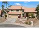 Beautiful two-story home with a terracotta roof, desert landscaping, and an inviting water feature in the front yard at 5530 E Beck Ln, Scottsdale, AZ 85254
