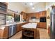 Well-equipped kitchen with an island, modern appliances, and a large window overlooking the backyard at 5530 E Beck Ln, Scottsdale, AZ 85254