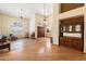 Open living area with wood floors, large windows, and views into dining area at 5530 E Beck Ln, Scottsdale, AZ 85254