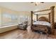 Spacious main bedroom featuring a four-poster bed, sitting area, and bright natural light at 5530 E Beck Ln, Scottsdale, AZ 85254