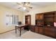 Office with built-in cabinets, desk, and a ceiling fan for ample lighting at 5530 E Beck Ln, Scottsdale, AZ 85254