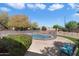 Backyard fenced pool area features lush landscaping and blue skies overhead at 5530 E Beck Ln, Scottsdale, AZ 85254