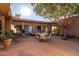 Inviting backyard patio boasts desert landscaping, outdoor seating, mountain views, and a built-in grill at 5970 N Echo Canyon Dr, Phoenix, AZ 85018