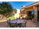 Patio features an outdoor grill, table with seating, and desert plants, perfect for entertaining in the Arizona sun at 5970 N Echo Canyon Dr, Phoenix, AZ 85018