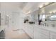 Bathroom featuring double sinks with generous counter space, bright lighting, and mountain views at 5970 N Echo Canyon Dr, Phoenix, AZ 85018