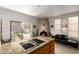 Open kitchen features an island with a cooktop, modern appliances, and a fireplace at 5970 N Echo Canyon Dr, Phoenix, AZ 85018