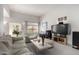 Cozy living space with comfortable seating, entertainment center, and a view to outdoor greenery at 5970 N Echo Canyon Dr, Phoenix, AZ 85018