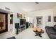 Open-concept living room with neutral tones, showcasing a large entertainment center and access to other rooms at 5970 N Echo Canyon Dr, Phoenix, AZ 85018
