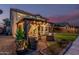 Landscaped backyard featuring a pergola with seating and string lights for outdoor enjoyment at 6804 S 45Th Gln, Laveen, AZ 85339