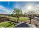 Lush backyard view with a green lawn, mature trees, and a charming gazebo at 6804 S 45Th Gln, Laveen, AZ 85339