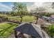Scenic backyard view with a green lawn, mature trees, and a charming gazebo providing a relaxing outdoor space at 6804 S 45Th Gln, Laveen, AZ 85339