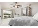 Bright bedroom with vaulted ceilings, fan, balcony access, and a neutral color scheme at 6804 S 45Th Gln, Laveen, AZ 85339