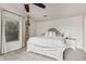 Bright bedroom featuring a large bed, neutral-toned walls and carpet, and a decorative shelving unit at 6804 S 45Th Gln, Laveen, AZ 85339