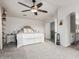 Bedroom features a king bed, light gray carpet, ensuite bathroom, and decorative shelving at 6804 S 45Th Gln, Laveen, AZ 85339