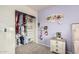 Bedroom with built-in closet shelves, modern light fixtures, and colorful decor at 6804 S 45Th Gln, Laveen, AZ 85339