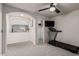 A cozy bedroom with a ceiling fan and a view to another living area separated by an arched opening at 6804 S 45Th Gln, Laveen, AZ 85339