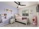 Charming bedroom decorated with colorful accents, including a small shelving unit and personalized decor at 6804 S 45Th Gln, Laveen, AZ 85339