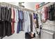 Walk-in closet offering ample storage with hanging rods, shelving, and a storage safe at 6804 S 45Th Gln, Laveen, AZ 85339