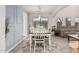 Dining room featuring a white table, modern chandelier, and blue accent wall at 6804 S 45Th Gln, Laveen, AZ 85339