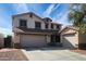 Stunning two-story home showcasing a three-car garage and a well-manicured front yard at 6804 S 45Th Gln, Laveen, AZ 85339