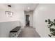 Upstairs hallway with modern light fixture, carpet flooring, and a bench by the railing at 6804 S 45Th Gln, Laveen, AZ 85339