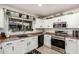 Well-appointed kitchen featuring white cabinets, stainless steel appliances, and a window view at 6804 S 45Th Gln, Laveen, AZ 85339