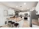 Bright kitchen with white cabinets, stainless steel appliances, and a breakfast bar with seating at 6804 S 45Th Gln, Laveen, AZ 85339