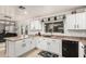 Charming kitchen with white cabinets, dark countertops, and a view to the backyard at 6804 S 45Th Gln, Laveen, AZ 85339