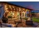 Outdoor patio area with comfortable seating, a grill, and string lights for evening ambiance at 6804 S 45Th Gln, Laveen, AZ 85339
