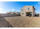 Spacious backyard with low-maintenance landscaping, block wall, and covered patio area at 6823 W Getty Dr, Phoenix, AZ 85043