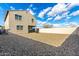 Large backyard featuring a covered patio, rock landscaping, and privacy block wall at 6823 W Getty Dr, Phoenix, AZ 85043