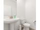 Half bathroom with pedestal sink, toilet, and neutral-toned flooring in a well-lit space at 6823 W Getty Dr, Phoenix, AZ 85043