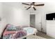 Bright bedroom boasts a ceiling fan, comfortable bed, and a functional layout at 6823 W Getty Dr, Phoenix, AZ 85043