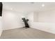 Spacious bonus room with plush carpeting, recessed lighting, and a treadmill for exercise at 6823 W Getty Dr, Phoenix, AZ 85043