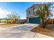 Two-story home with a blue garage door and desert landscaping at 6823 W Getty Dr, Phoenix, AZ 85043