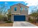 Two-story home with a blue garage door, desert landscaping, and neutral paint scheme at 6823 W Getty Dr, Phoenix, AZ 85043