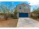Two-story home with a blue garage door, desert landscaping, and neutral paint scheme at 6823 W Getty Dr, Phoenix, AZ 85043