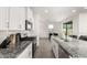 Modern kitchen with white cabinets, granite countertops, tile backsplash, and stainless steel appliances at 6823 W Getty Dr, Phoenix, AZ 85043