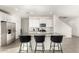 Bright kitchen with white cabinets, stainless steel appliances, and large island with seating at 6823 W Getty Dr, Phoenix, AZ 85043