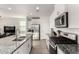 Open kitchen with stainless steel appliances, white cabinets, and granite countertops at 6823 W Getty Dr, Phoenix, AZ 85043