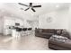 Open-concept living room with tile flooring, ceiling fan and comfortable seating at 6823 W Getty Dr, Phoenix, AZ 85043