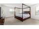 Primary bedroom featuring a four-poster bed, plush carpet, and a serene atmosphere at 6823 W Getty Dr, Phoenix, AZ 85043