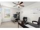 Spacious home office with a ceiling fan, dual desks, and natural lighting at 6823 W Getty Dr, Phoenix, AZ 85043