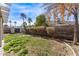 Backyard features a grass area and mature trees and shrubs, offering a private outdoor oasis at 6925 W Maldonado Rd, Laveen, AZ 85339