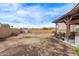 Large backyard offering ample space and privacy, with a covered patio area, ready for your personal touch at 6925 W Maldonado Rd, Laveen, AZ 85339
