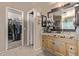 Neutral-toned bathroom features a granite countertop vanity and access to the walk-in closet at 6925 W Maldonado Rd, Laveen, AZ 85339