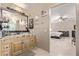 Bright bathroom with a granite countertop vanity and a view of the bedroom at 6925 W Maldonado Rd, Laveen, AZ 85339