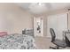 Bedroom with neutral walls and carpet, a ceiling fan, and a workstation near the closet at 6925 W Maldonado Rd, Laveen, AZ 85339