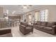 Open concept living area featuring tile flooring, a breakfast bar, a sofa, and a sliding glass door at 6925 W Maldonado Rd, Laveen, AZ 85339
